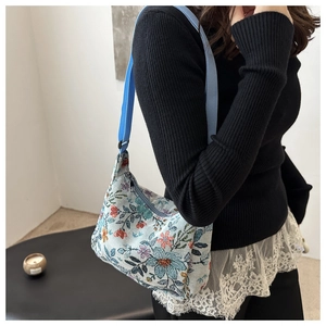 Close-up of floral jacquard fabric and intricate weave patterns on this large shoulder bag