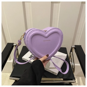 Detail view of heart-shaped lavender PU leather handbag with gold metal zipper and strap