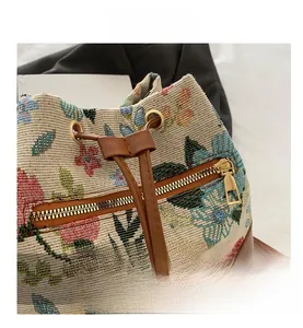 Close-up of floral jacquard fabric and faux leather drawstring on the bucket bag