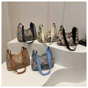 Detailed row of floral print hobo bags in assorted colors on minimalist white steps