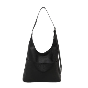 Minimalist black faux leather tote bag with large pocket and long shoulder strap