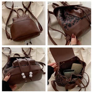 Detail view of mini brown leather backpack with leopard print trim and drawstring
