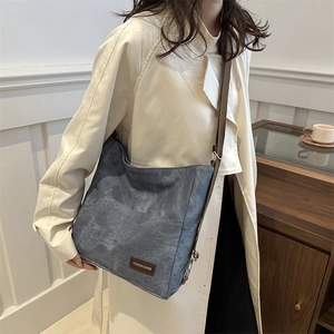 Minimalist vintage dark blue canvas backpack with adjustable brown strap for women