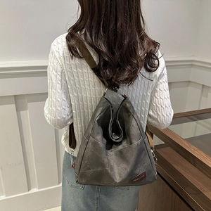 Minimalist charcoal grey canvas backpack for women in a stylish casual travel style
