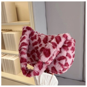 Detail view of pink leopard faux fur shoulder bag with soft plush texture and wide handle