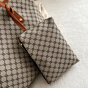 Detail of vintage patterned bag charm with leather strap and premium gold metal hardware