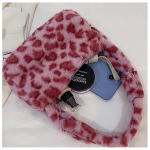 Interior view of leopard print plush bag showing storage space for phone and makeup