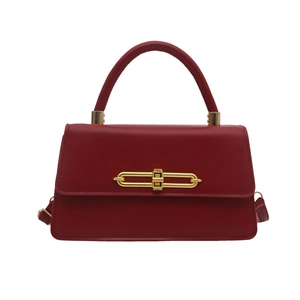 Chic red faux leather crossbody bag with elegant gold metal twist lock and top handle