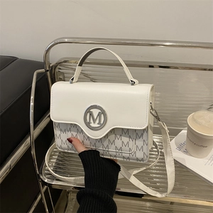 Chic white crossbody bag with grey letter monogram and round silver metallic M logo