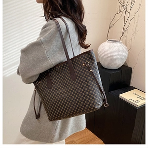 Detail of vintage tote bag with geometric print, side drawstring, and brown straps