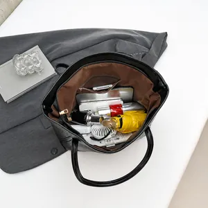 Interior view of black leather tote bag showing large capacity for tablet and accessories