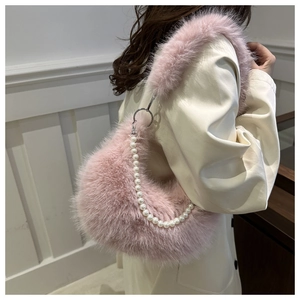 Détail du sac à bandoulière rose en fausse fourrure avec chaîne en perles blanches et anneau