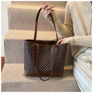 Detail shot of vintage brown tote bag with geometric pattern in a lifestyle setting
