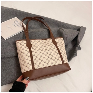 Close-up of retro tote bag featuring brown geometric floral print and durable faux leather base