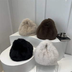 Winter fluffy faux fur handbags in cream, brown, black and white displayed on a podium
