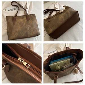 Detail view of large brown vintage tote bag with textured leather and spacious interior