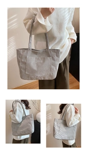 Three-way view of a large corduroy tote bag in light grey with branding label