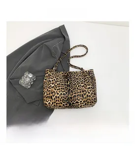 Detailed view of leopard print tote bag texture with sleek shoulder straps and canvas material