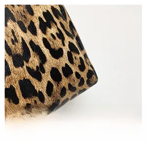 Detailed close-up of premium leopard print tote bag with realistic grainy leather texture