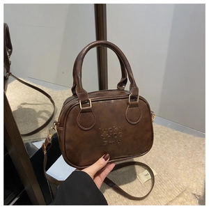 Detailed close-up of vintage brown PU leather bag with embossed Lucky LHCO Fmu lettering