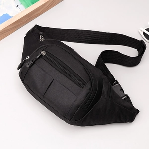 Detail of black nylon chest bag showing multiple zipper pockets and adjustable buckle strap