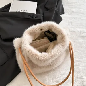 Spacious interior of beige faux fur tote bag showing phone, wallet and sunglasses