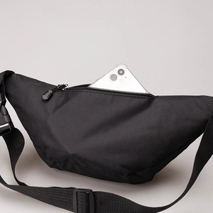 Detail of black canvas waist bag showing its spacious capacity for a smartphone