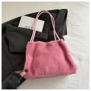 Detailed macro view of soft pink faux fur texture on a plush tote bag with slim handles