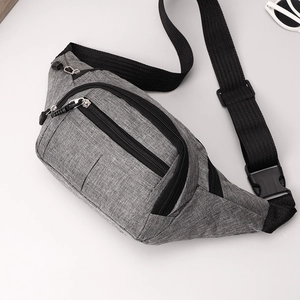 Close-up of grey fabric texture and durable black zippers on the multi-pocket waist bag