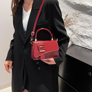 Elegant retro red patent leather crossbody bag with top handle and gold hardware