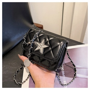 Détail du sac bandoulière noir matelassé avec boucle étoile en strass et bandoulière chaîne
