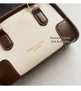 Detail of cream faux leather pillow bag with brown trim and soft textured fabric