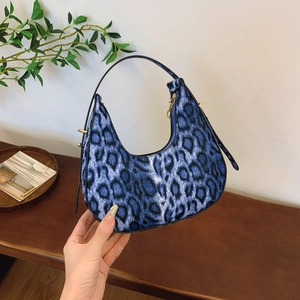 Blue leopard print crescent hobo bag with adjustable strap and gold metal zipper