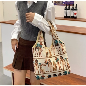 Close-up of canvas bucket bag featuring Egyptian art print and spacious interior design