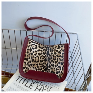 Detail of vintage leopard print crossbody bag with high-quality burgundy leather trim