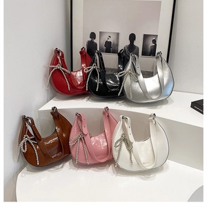 Detailed display of crescent hobo bags in six colors with pearl bow charms and fashion logo