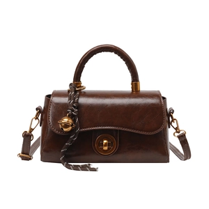Vintage dark brown oil wax leather crossbody bag with gold hardware and woven charm