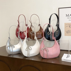 Chic hobo bags in assorted colors featuring pearl bow pendants and faux leather finish