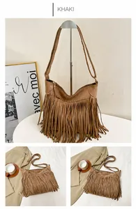 Close-up of khaki faux suede tote bag with fringe tassels and adjustable strap details