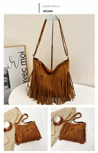 Close-up of brown faux suede shoulder bag featuring bohemian tassel detail and zip closure