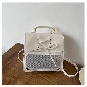 Detail of beige multi-functional backpack with clear front pocket and bow tie decor
