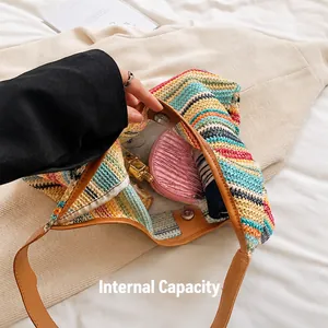 Top view of striped woven tote bag showing spacious interior with brown leather strap