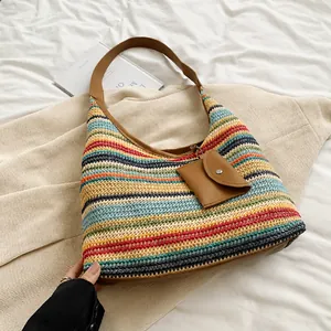Close-up of colorful bohemian woven tote bag with brown leather strap and coin purse
