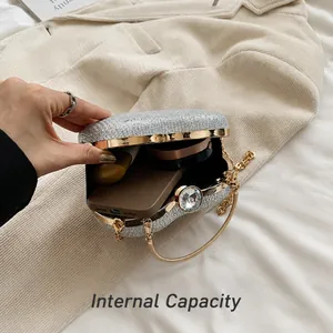 Inside view of silver glitter evening bag showing interior space for phone and makeup