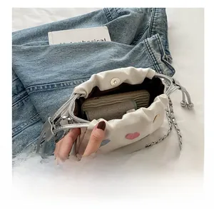 Top view of white canvas bucket bag interior showing capacity for phone and card holder
