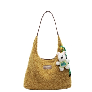 Mustard yellow plush tote bag with brown leather straps and cute puppy doll charm