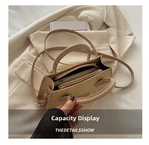 Detail view of the spacious inner compartment of the beige woven crossbody bag