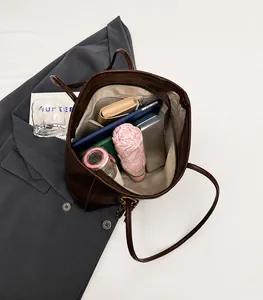 Interior view of large capacity dark brown tote bag showing daily essentials and storage