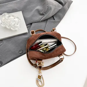 Interior storage capacity of the brown velvet crossbody bag for phone and lipstick