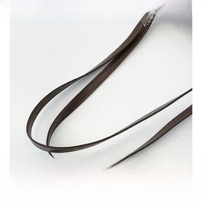 Detail view of the brown leather shoulder strap with durable stitching and comfort grip